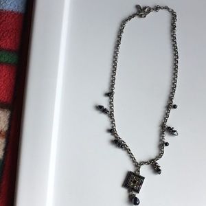 Necklace with blues and greens reflective stones depending on light.